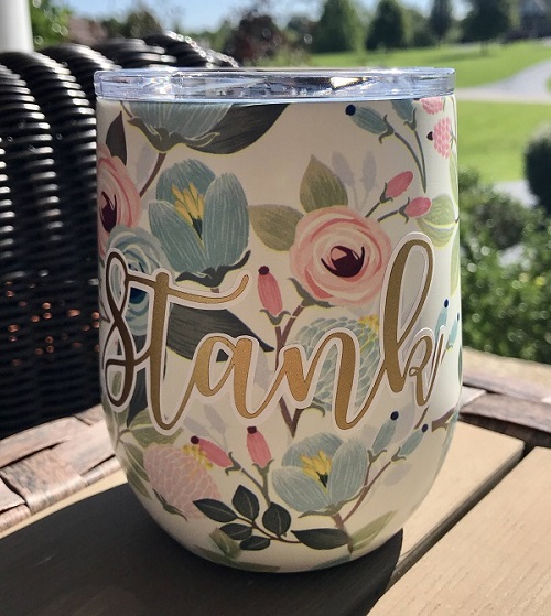 Floral Drink Tumbler-in white background with pretty floral design personalized with a name in gold vinyl